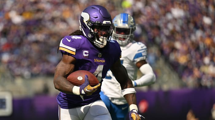 Vikings running back Dalvin Cook (4) runs the ball as Lions cornerback Amani Oruwariye (24) pursues during the second quarter at U.S. Bank Stadium.